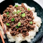 Korean Ground Beef Bowls — Soy glaze with rice and sesame seeds 3 Korean Ground Beef Bowls with Soy Glaze and Sesame Seeds