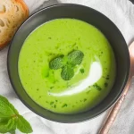 Spring Pea and Mint Soup in a Bowl with Fresh Herbs