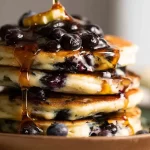 Fluffy Blueberry Pancakes Drizzled with Maple Syrup