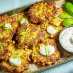 Delicious Corn Fritters with Sour Cream on a Plate