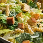 Caesar Pasta Salad with Romaine and Croutons on a Plate