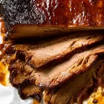 Beef Brisket: The Ultimate Guide to Delicious Perfection 3 Perfectly Cooked Beef Brisket on a Wooden Board