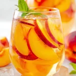 Peach Sangria: Refreshing Delight for Summer Sips 3 Refreshing Peach Sangria in a Pitcher