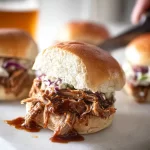 Pulled Pork Sliders: The Perfect Crowd-Pleasers! 3 Mouthwatering Pulled Pork Sliders on a Serving Platter
