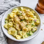 Classic Potato Salad in a bowl with fresh herbs